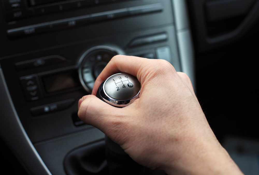 close up of hand on manual gear shift knob